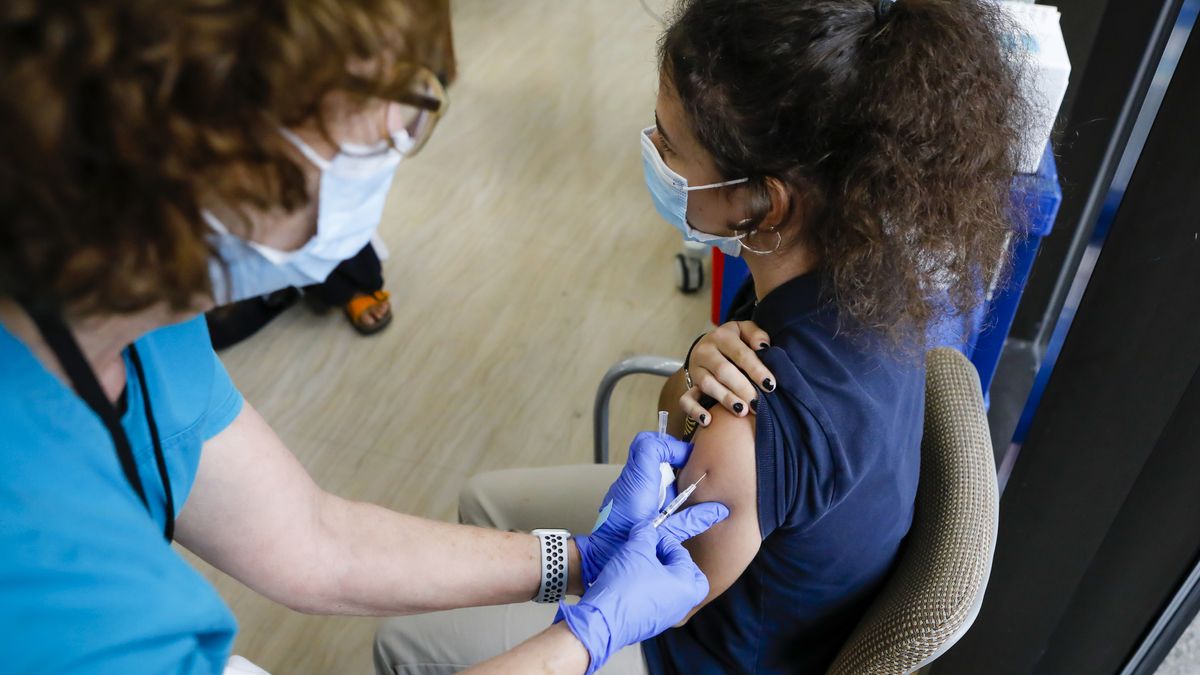 A health care worker administers a dose of the Pfizer-BioNTech COVID-19 vaccine to a teenager at Holtz Children&#039;s Hospital in Miami, Florida, on May 18, 2021.