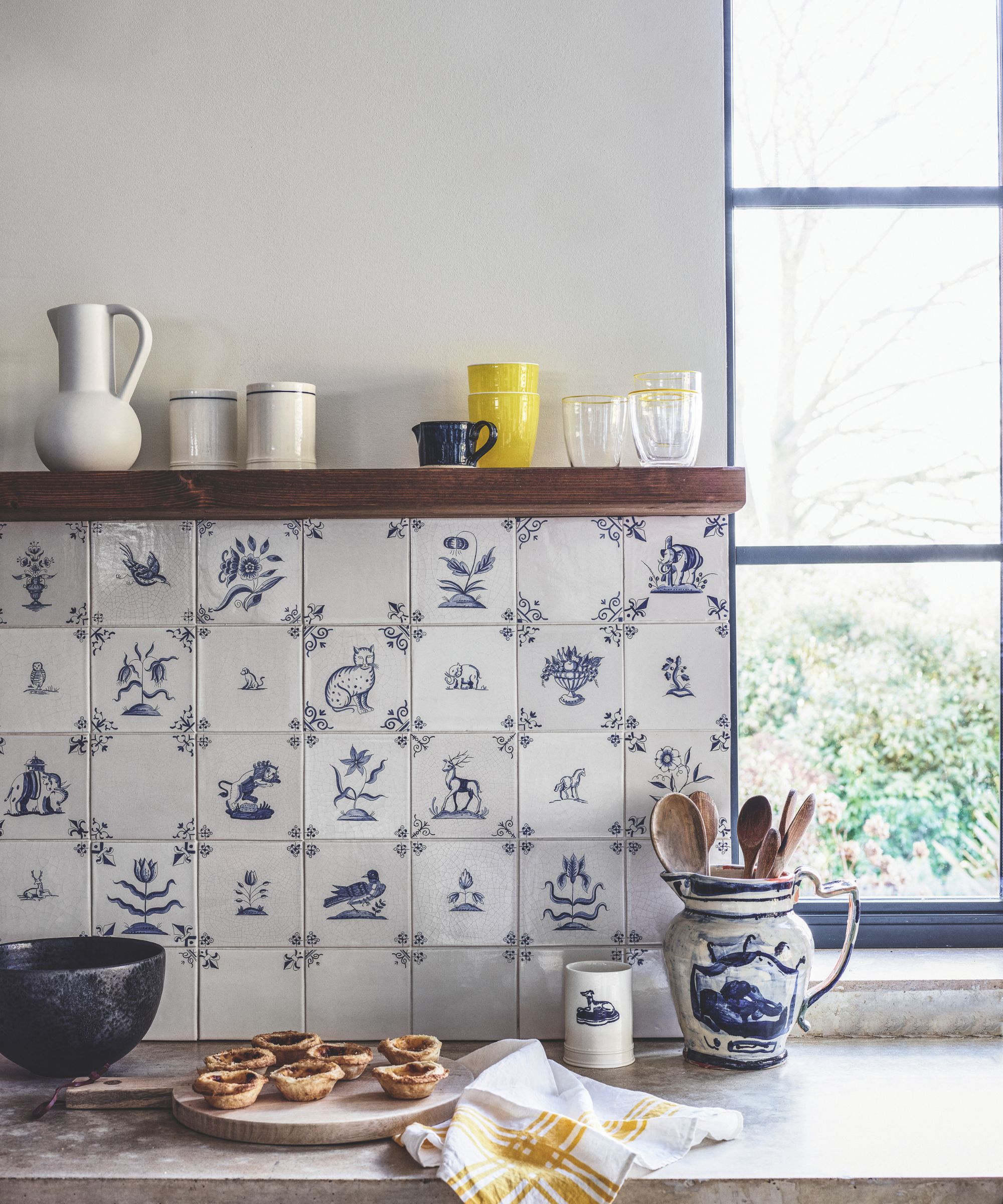 Plate of pies on a kitchen sideboard with blue and white tiles behind