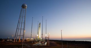 An Orbital Sciences-built Antares rocket stands atop its launch pad at sunrise on Oct. 26, 2014, one day ahead of a planned evening launch from NASA's Wallops Flight Facility on Wallops Island, Virginia. 