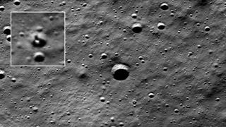 spacecraft photo of the cratered lunar surface, with a white-box enlargement showing the location of a lander inside a crater