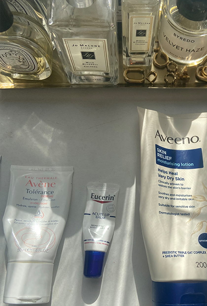 Vanity table with Eucerin lip balm, skincare products, perfumes and jewellery tray