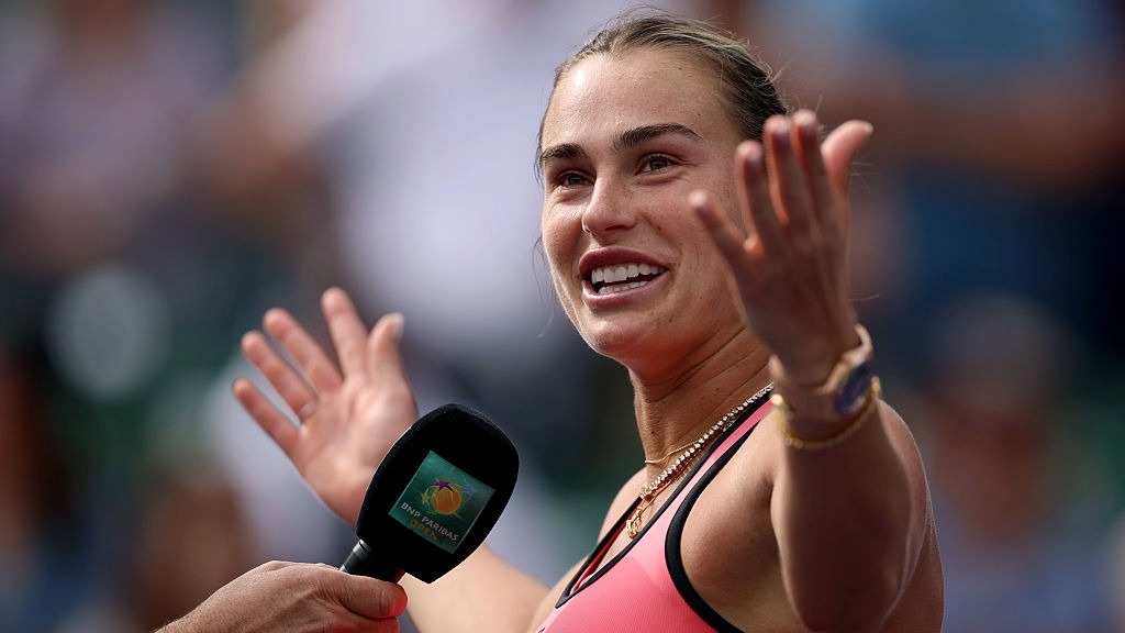 Aryna Sabalenka talks into a microphone while being interviewed on court at Indian Wells 2026