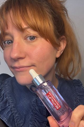 a picture of matilda holding a bottle of the loreal hyaluronic acid serum