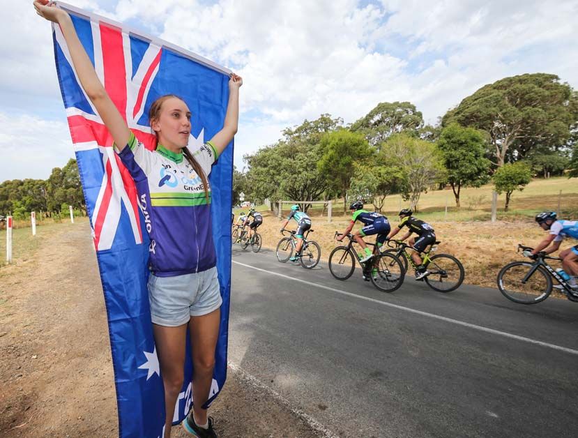 A fan cheers on the riders as they pass