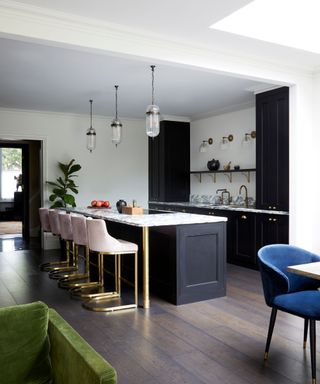 Black kitchen island and cabinets, white walls