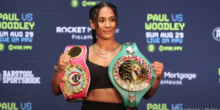 Amanda Serrano poses with her two belts at press conference for her boxing match with Yamileth Mercado