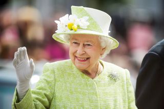 queen elizabeth in a green hat and jacket
