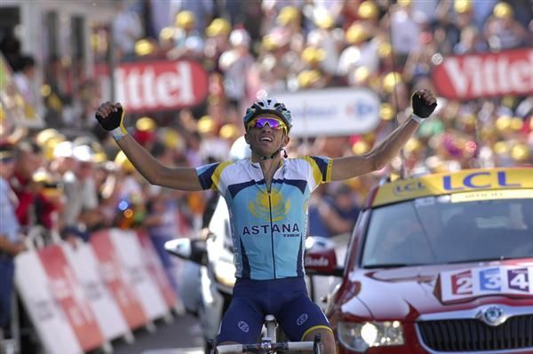 Who's the boss? Alberto Contador flexes his muscles as he crosses the line for his stage victory