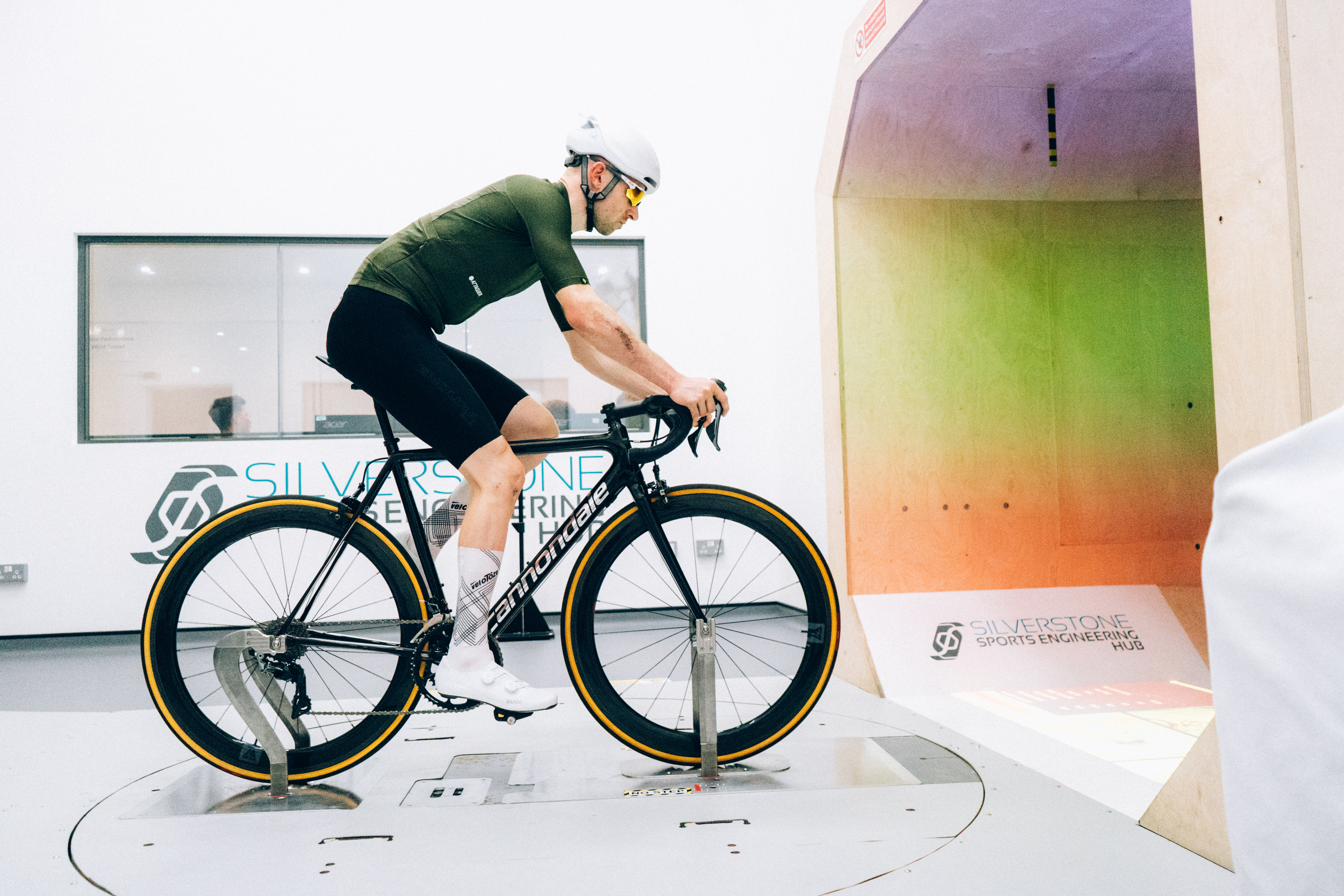 Tom riding his Cannondale in the wind tunnel wearing some Velotoze Aero Socks