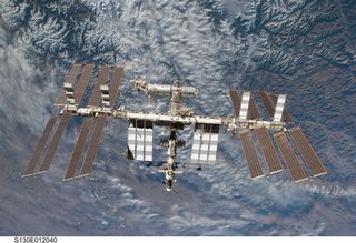 Backdropped by rugged Earth terrain, the International Space Station is featured in this image photographed by an STS-130 crew member on space shuttle Endeavour after the station and shuttle began their post-undocking relative separation.