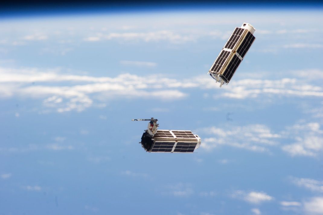 Two of the 28 Dove cubesats that make up Planet Lab&#039;s &quot;Flock 1&quot; constellation are seen deploying into orbit from the International Space Station on Feb. 11, 2014.