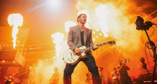 Kevin Jonas of the Jonas Brothers performs live with a white Les Paul