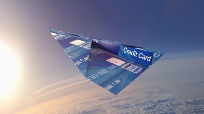 Credit card paper airplane flying above the Earth