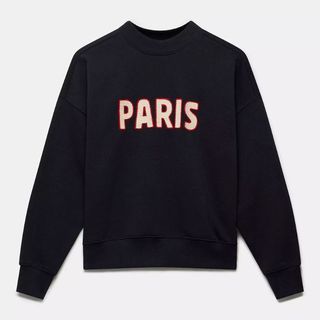 A cutout image of a dark sweatshirt with the words Paris on them