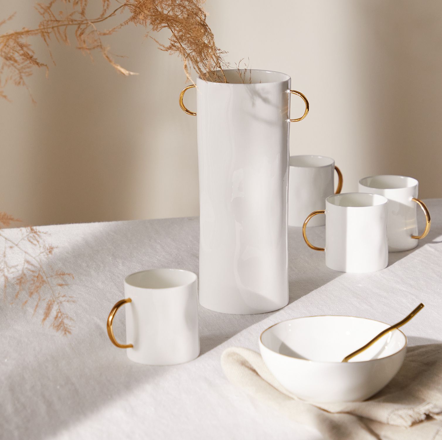 gold edged ceramics on a linen tablecloth