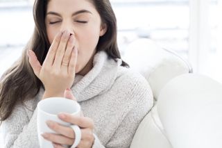 Adrenal fatigue symptoms: A woman yawning