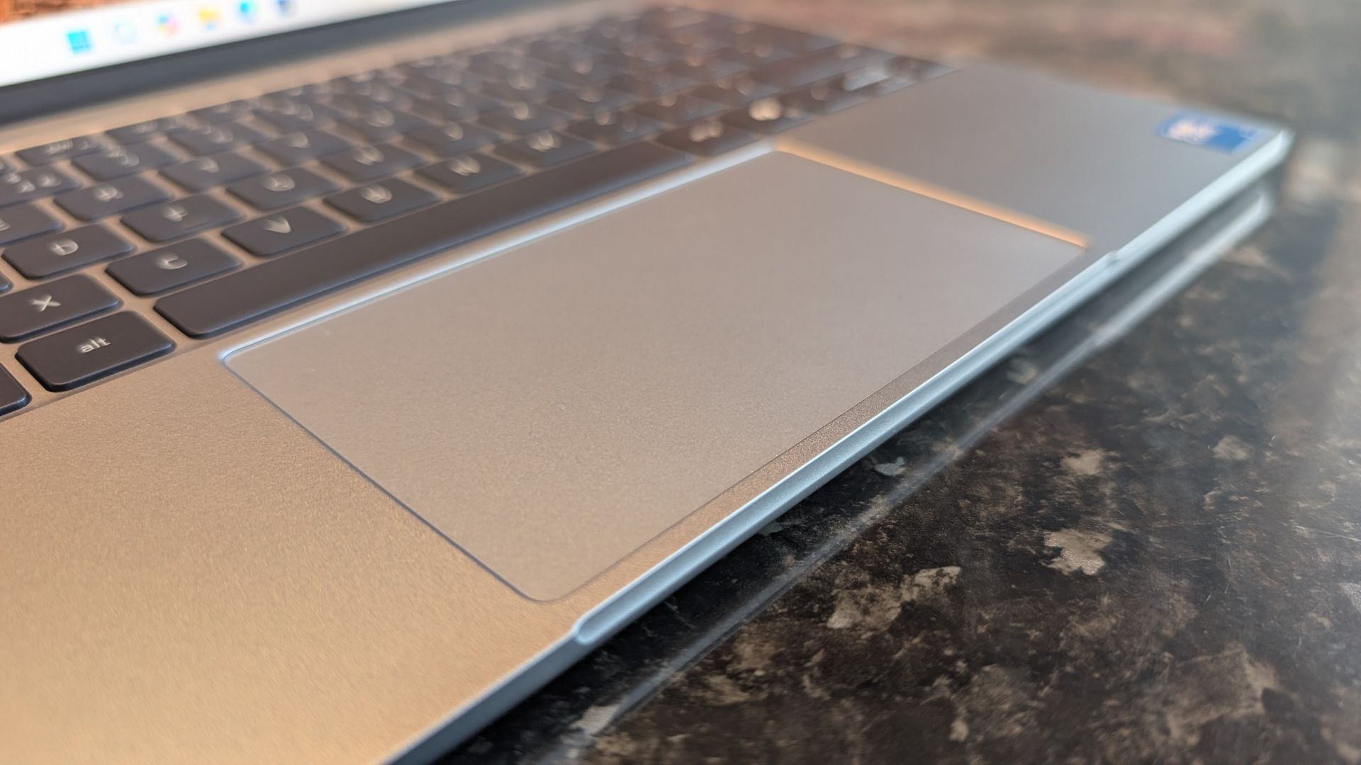The Dell XPS 13 (2026) laptop pictured on a black marble worktop.