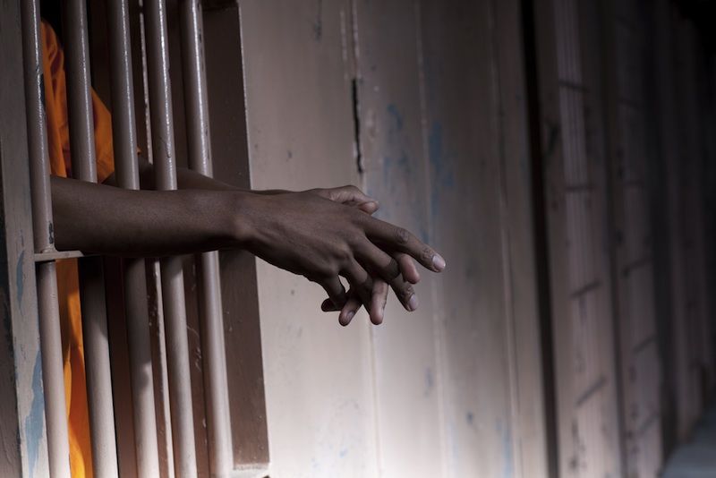 A jail cell with an inmate.