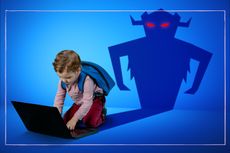 child on computer with monster behind