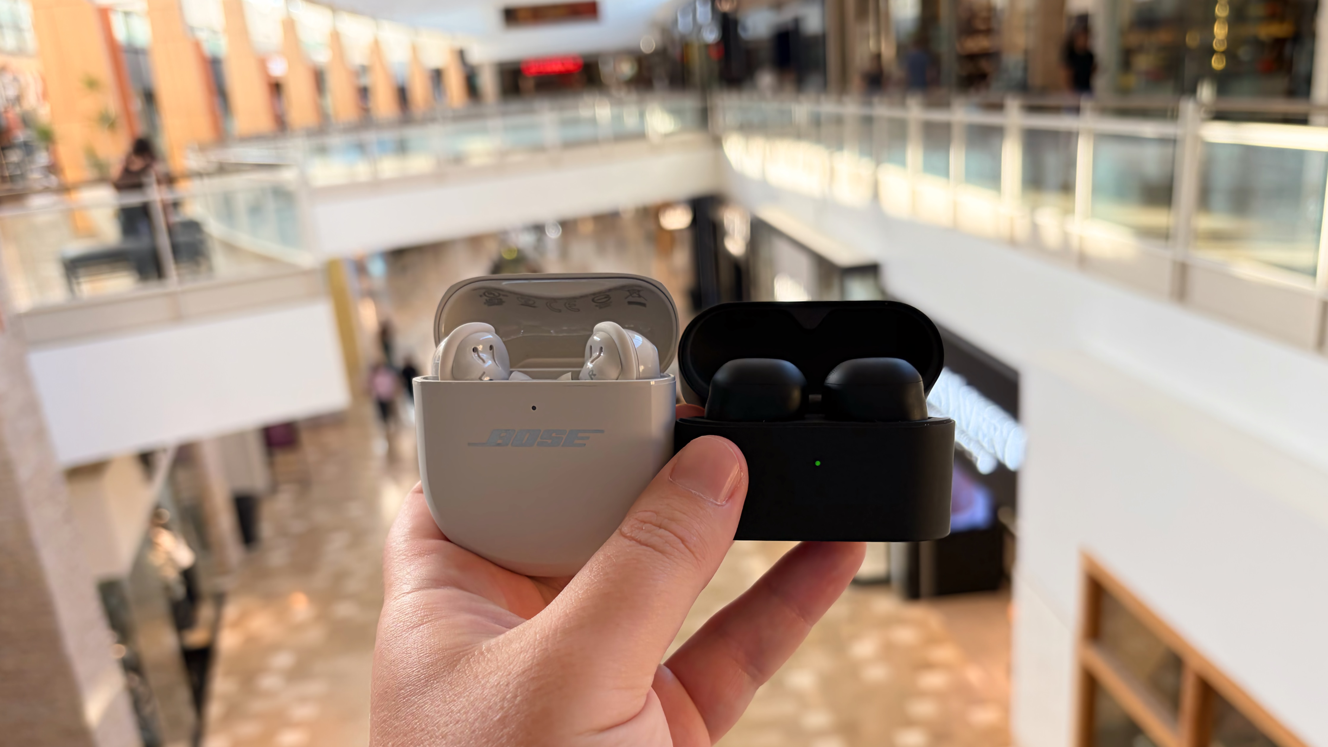 The Sony WF-1000XM6 and the Bose QuietComfort Ultra Earbuds at a mall.