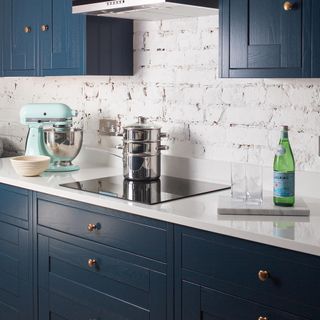 kitchen with blue cabinets and white coutertop