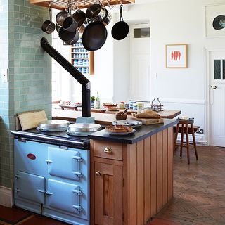 kitchen with white wall wooden cabinet blue aga and wooden cabinet