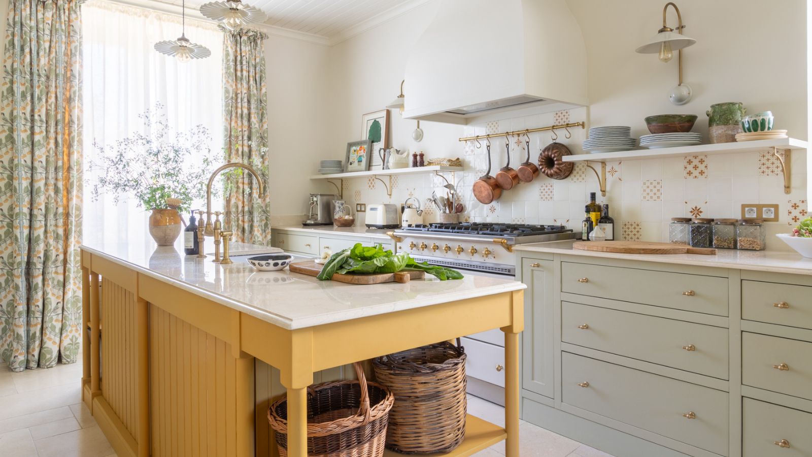 A French country kitchen with pale blue cabinets, a yellow island, and white walls