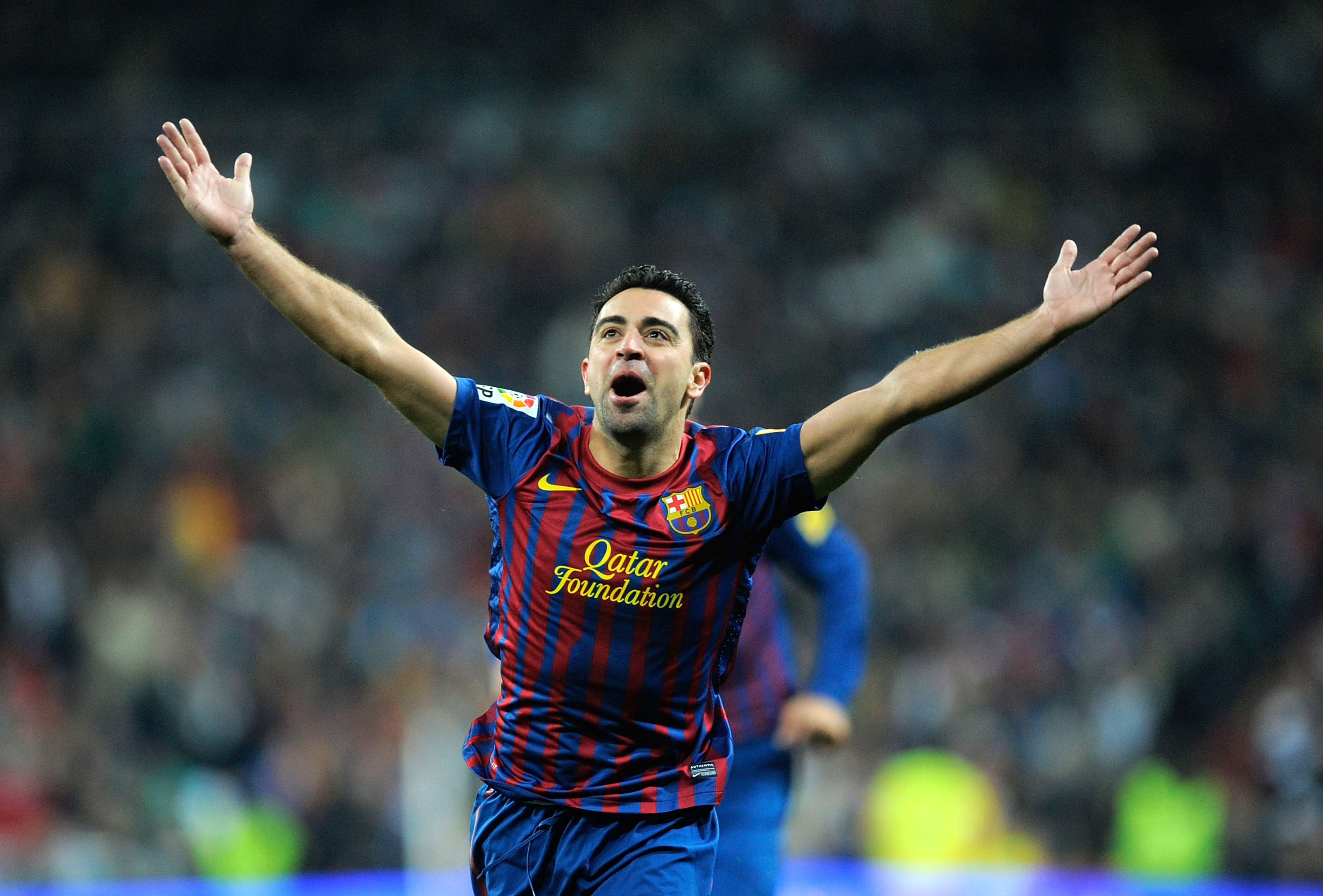 Xavi celebrates after scoring for Barcelona against Real Madrid in December 2011.