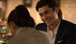 Crazy Rich Asians Henry Golding smiling in a suit
