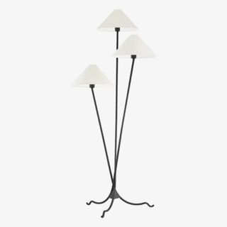 A metal floor lamp with three white shades from McGee & Co.