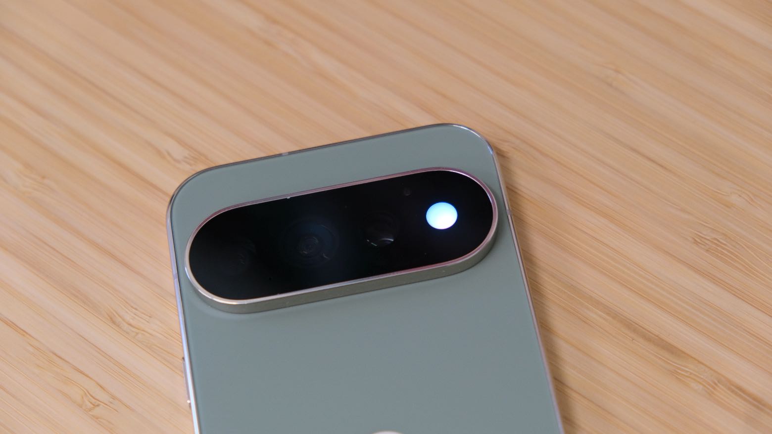 The Google Pixel 11 Pro resting on a wooden table