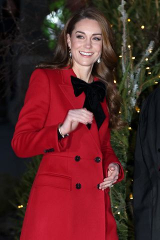 Princess Kate arrives at Westminster Abbey for her fourth annual Together at Christmas Carol service wearing a red bow topped coat