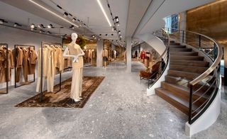 Interior of Max Mara's Boutique showing sweeping staircase, clothes rails and a mannequin