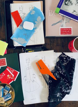 Erdem’s desk with reference material, fabric swatches ,drawings