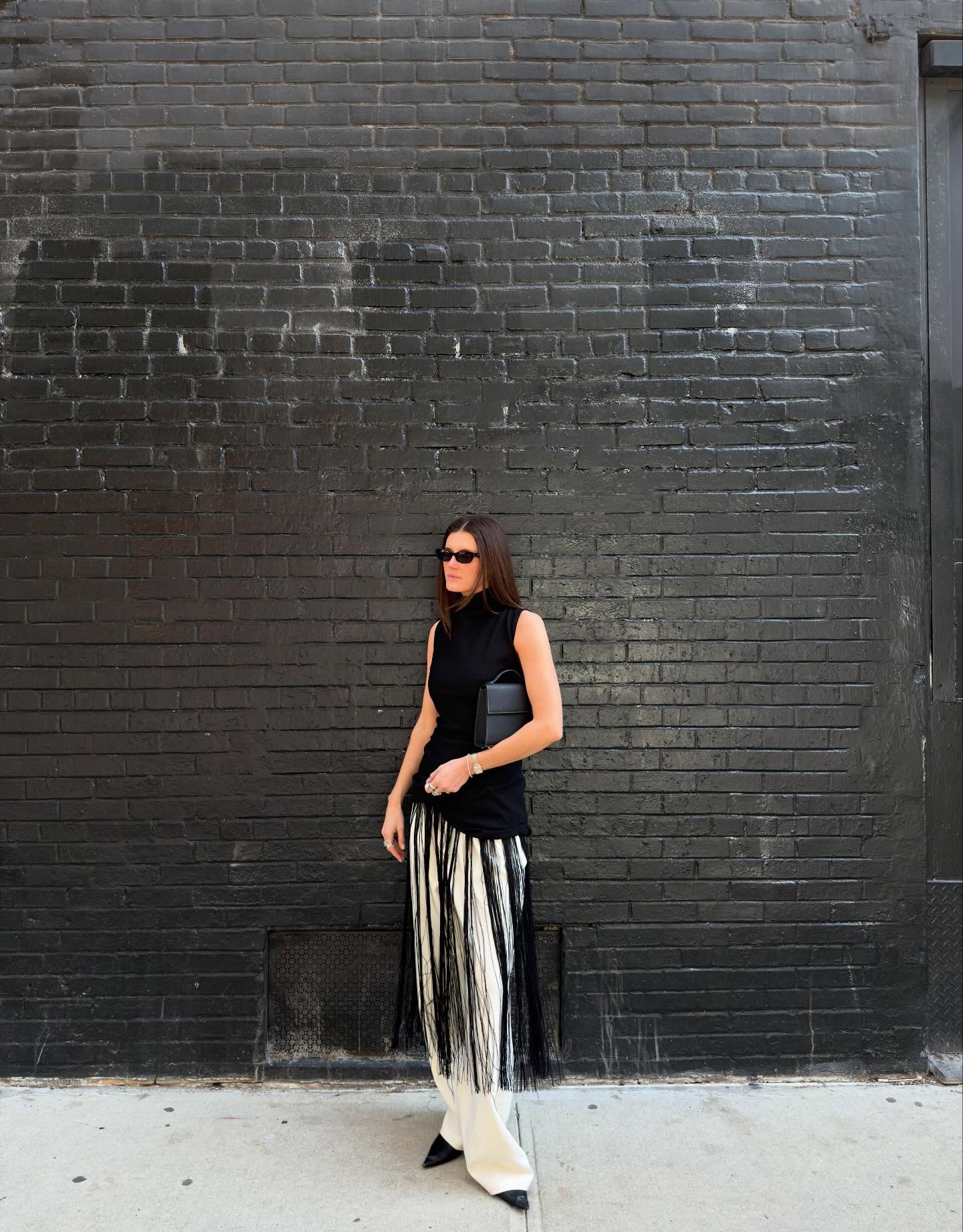 Coco Shiffer wearing a fringe black top
