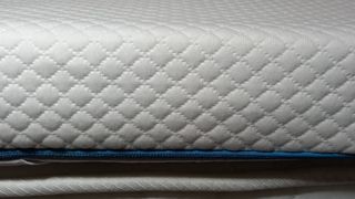 Closeup on Simba Hybrid Essential Mattress Topper, sitting on mattress