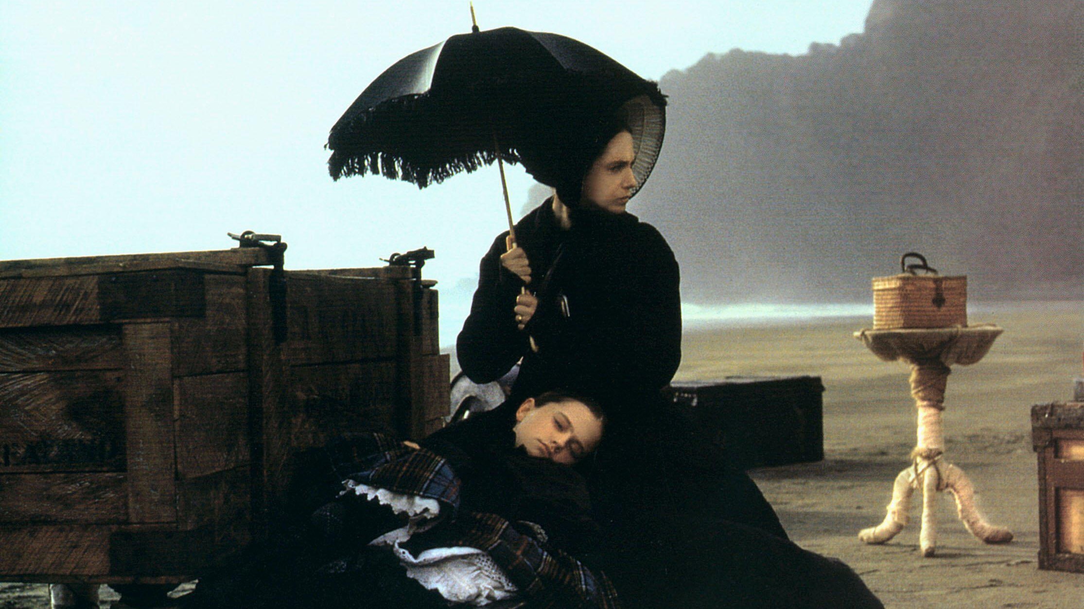 Anna Paquin lies in Holly Hunter's lap on a beach in The Piano