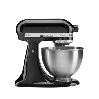 A black KitchenAid standing mixer with a stainless steel bowl on it