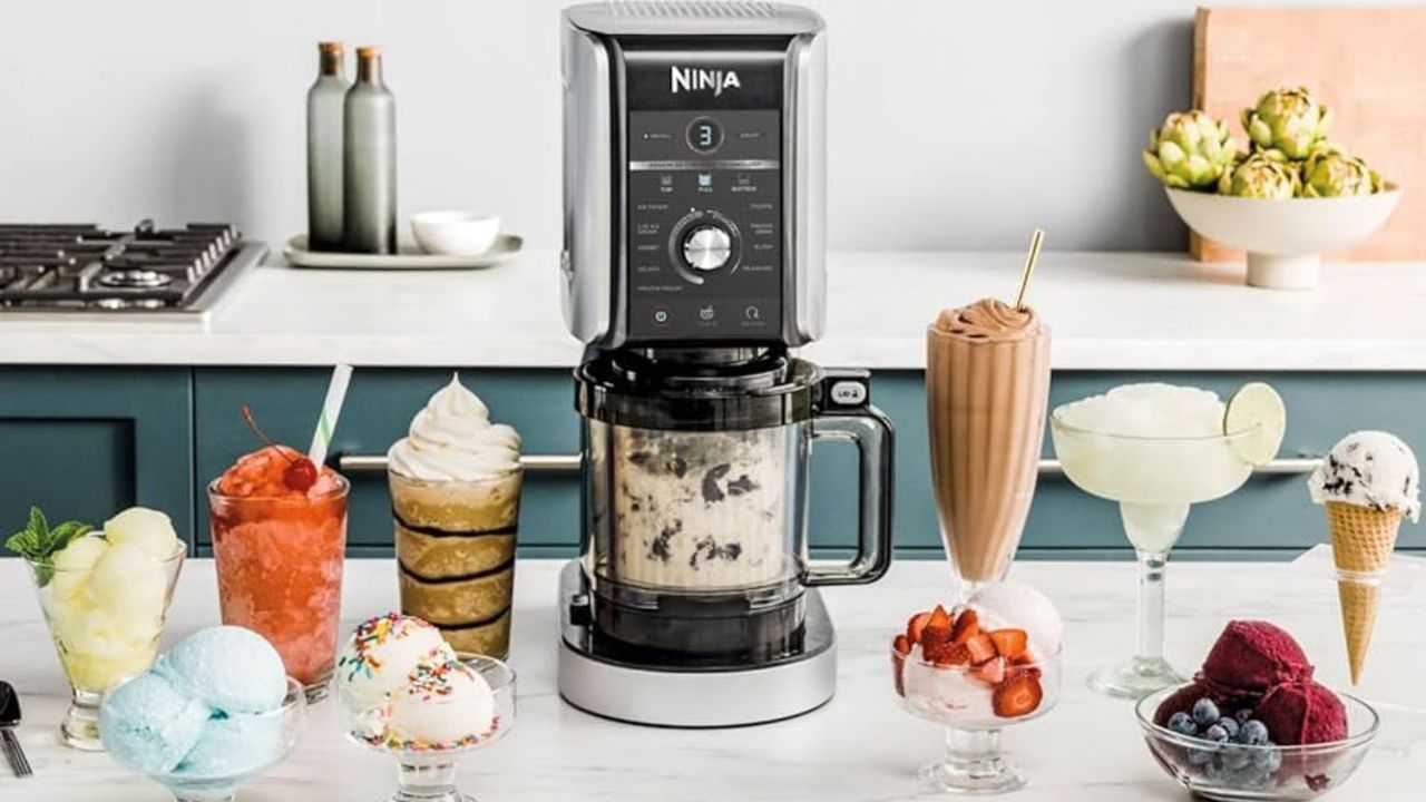 Ninja Creami Deluxe Ice Cream Maker on a countertop with frozen drinks, sorbet, ice cream and more arount it