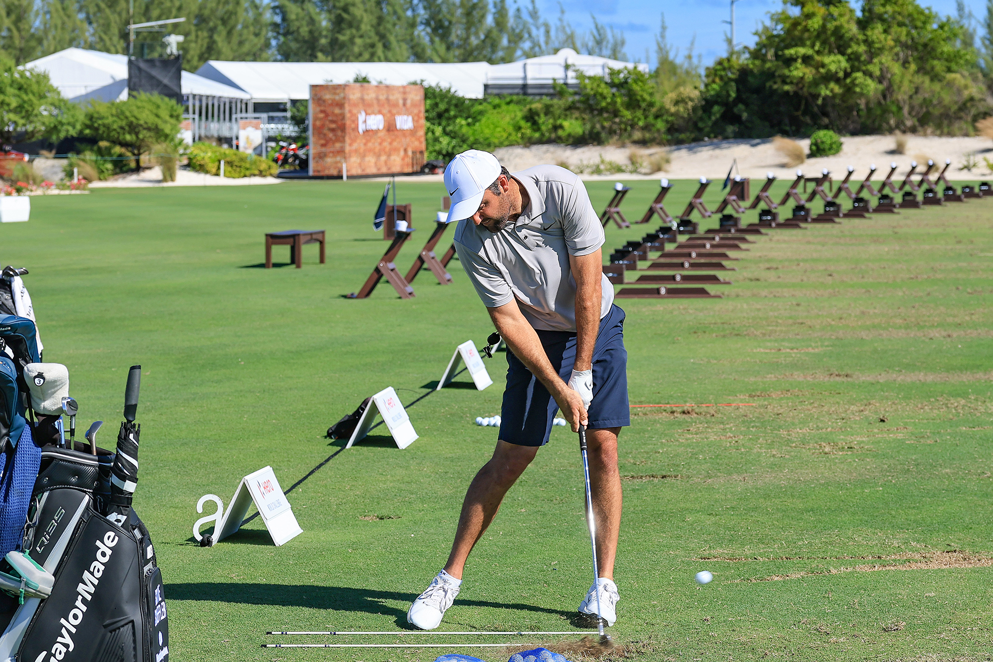 Scottie Scheffler practicing on the range, with the ball flying off the middle of the clubface