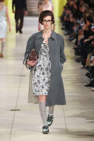 Model wears contrast trainers on the Miu Miu autumn/winter 2025 runway.