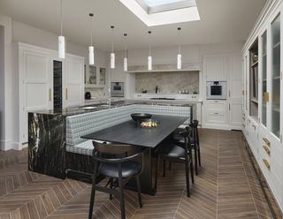 Kitchen island with inset banquette and dining table