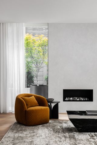 living space with brown armchair