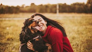 Loving dog with owner in red jumper