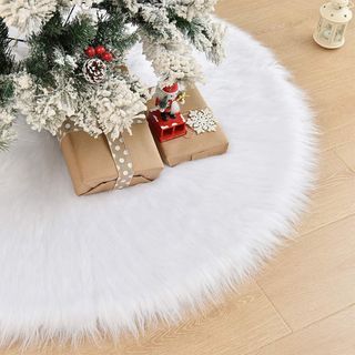 WEYON Christmas Tree Skirt in white faux fur underneath tree with presents on top