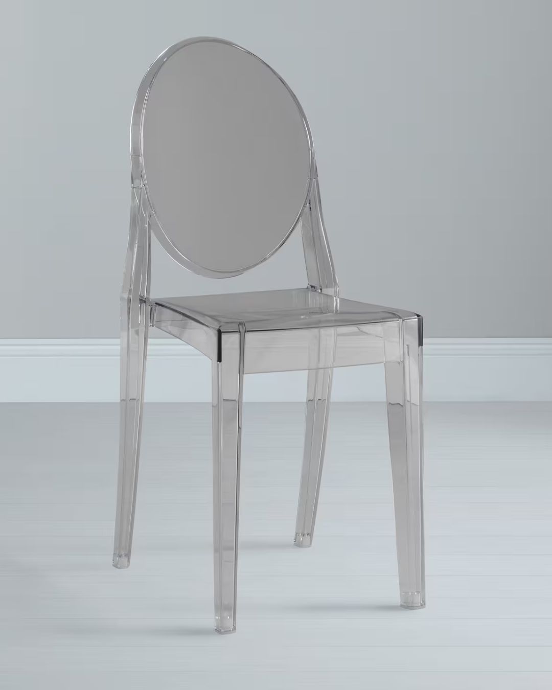 Ghost, transparent chair styled in gray room.