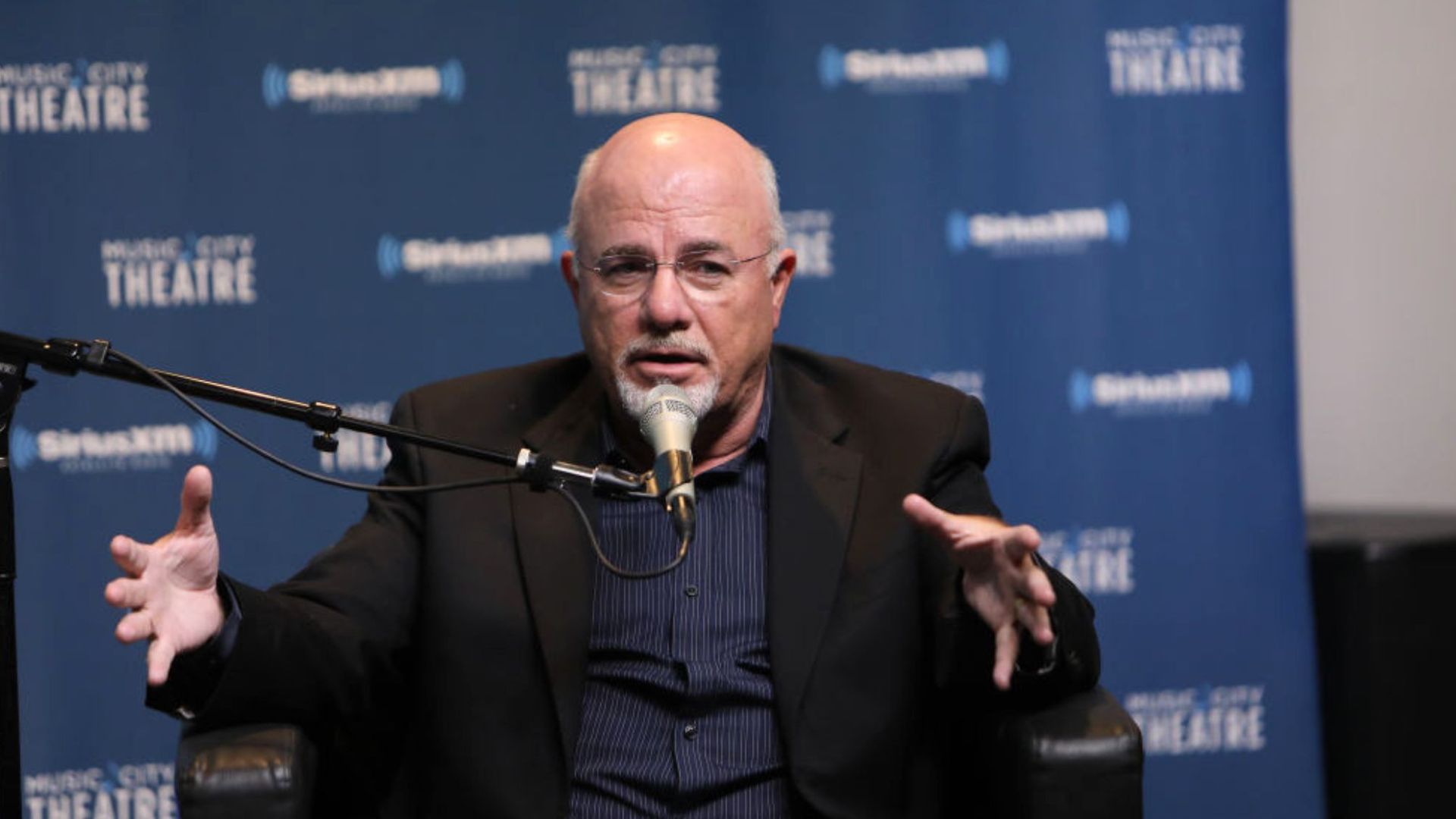 Money expert Dave Ramsey talks at an event.