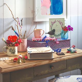 A craft room with an upcycled wooden desk and a two-toned wall