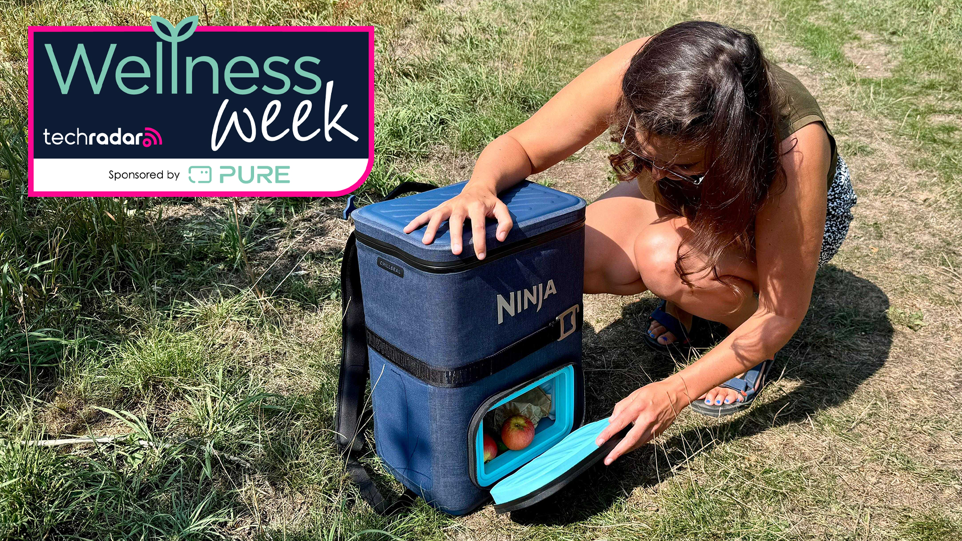 Writer opening Ninja FrostVault Go backpack, with Wellness Week logo overlaid