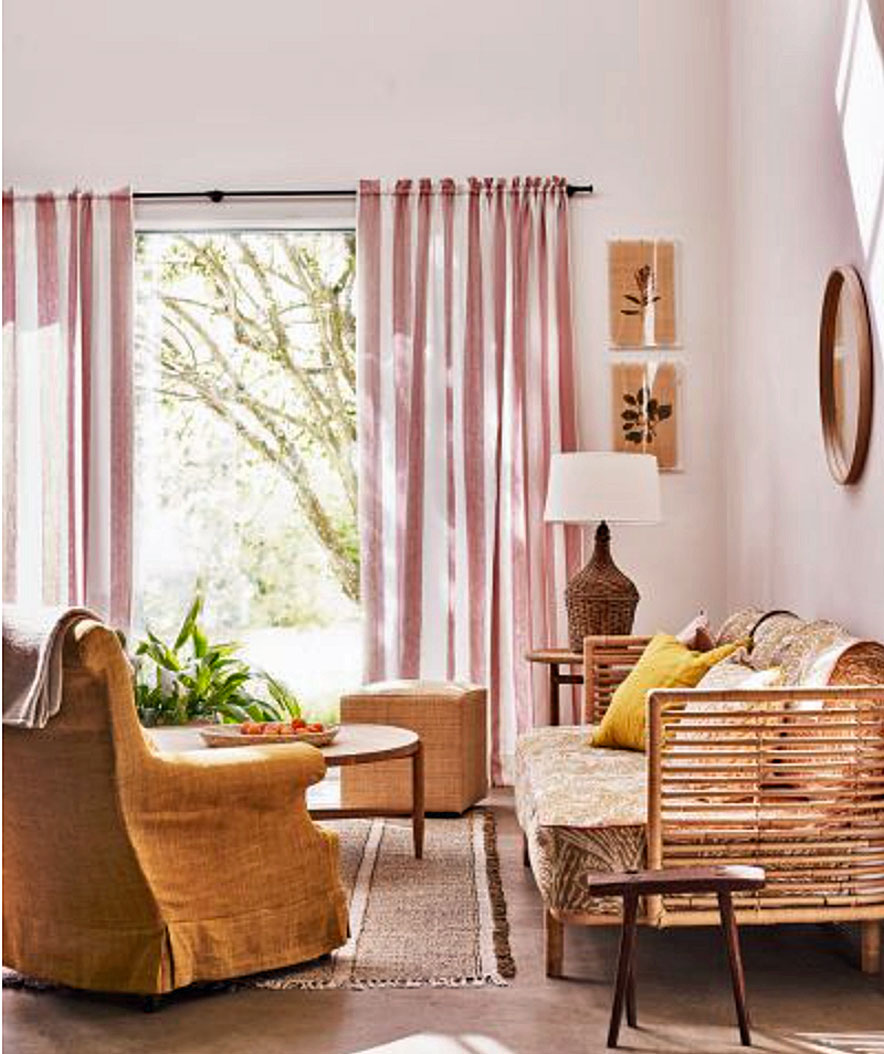 Living room color schemes in earthy hues, with pastel pink walls, wooden furniture and ochre accents.